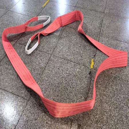 5T red webbing sling laid out with flat reinforced eyes at both ends