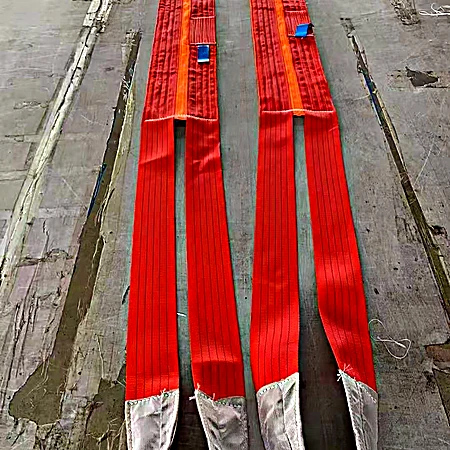 Two heavy duty eye and eye flat web slings in red with reinforced eyes and wear pads