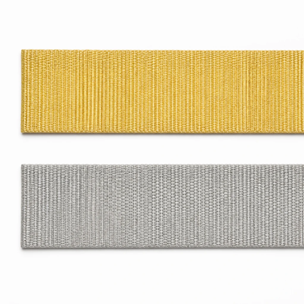 Golden aramid webbing band above a silver-grey polyester webbing band of the same width, side by side