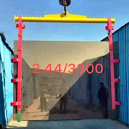 Glass lifting sling pair hanging vertically from a yellow spreader beam, holding a glass sheet