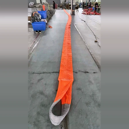 Full length of a heavy duty polyester strap laid straight down a factory aisle