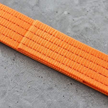 Close-up of the lapped and stitched joint of an endless web sling showing dense parallel rows of stitching across the webbing lap