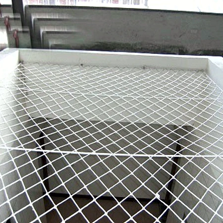 Stairwell void net fixed across the stair opening Horizontal staircase safety net fixed across a stairwell void with edge rope and corner fixings