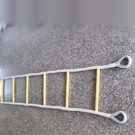 Full length nylon rope ladder laid out on a granite floor showing even rung spacing and braided stringers