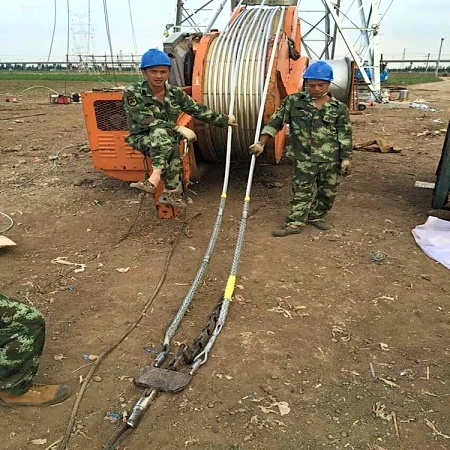Cable pulling grips in use pulling power cable from a drum on a construction site
