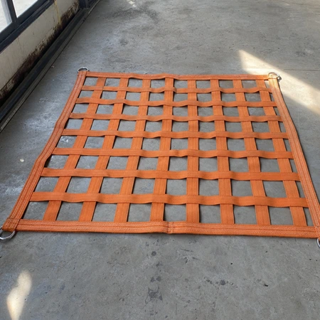 Webbing net laid out flat — 50 mm orange polyester bands woven into a 100 mm square mesh.